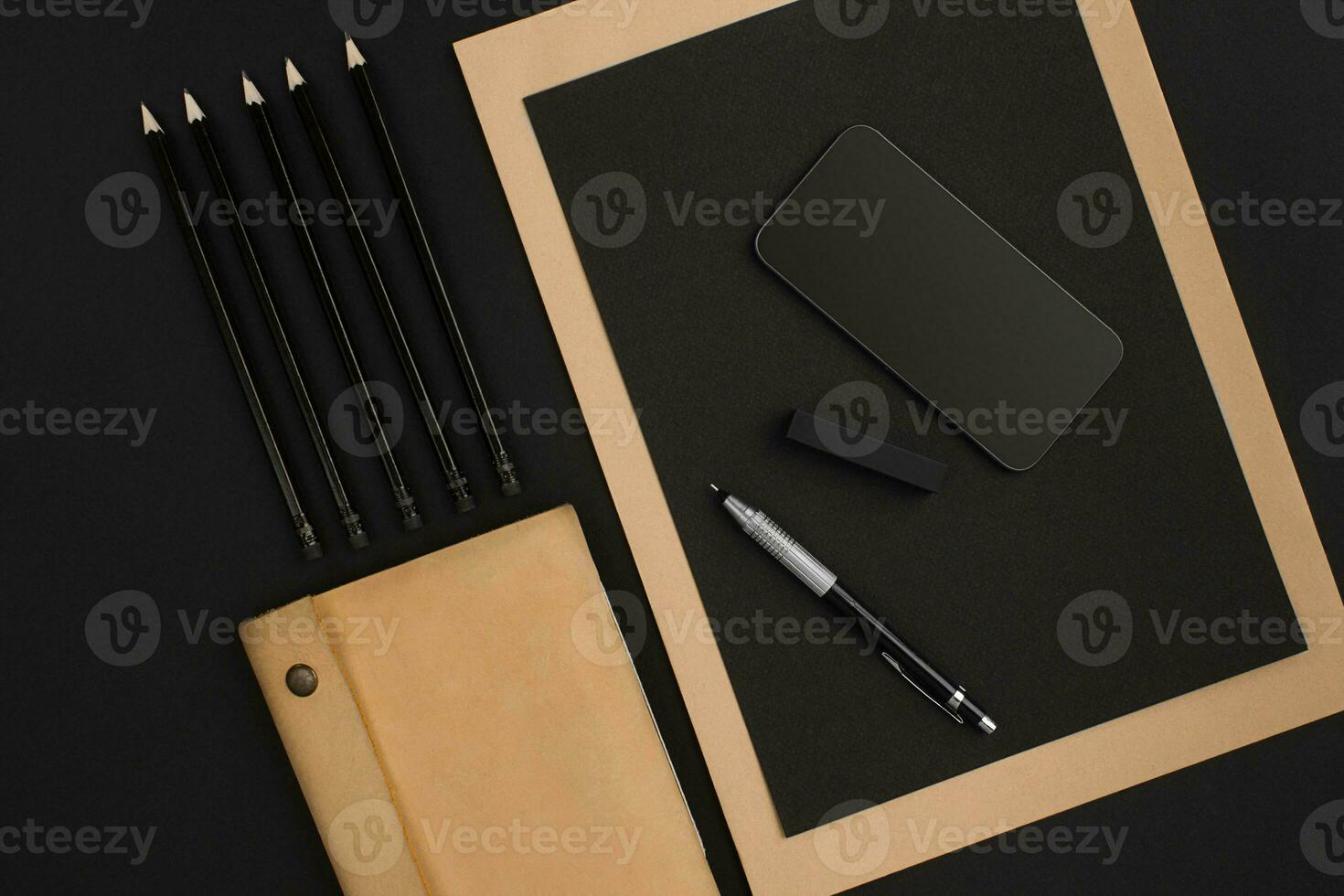 Top view of office supplies on blackboard background with copy space. photo