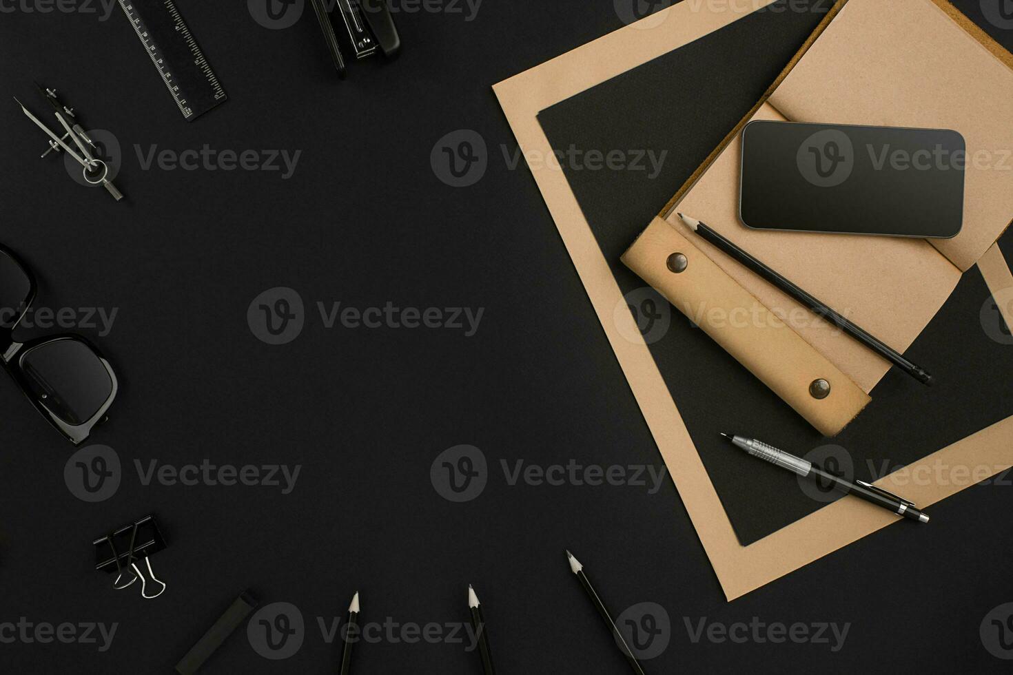 Office desktop with various black objects on background photo