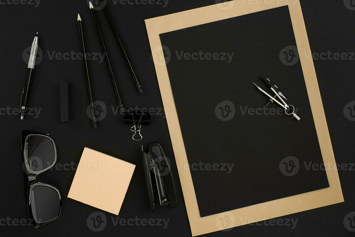 Office desktop with various black objects on background photo