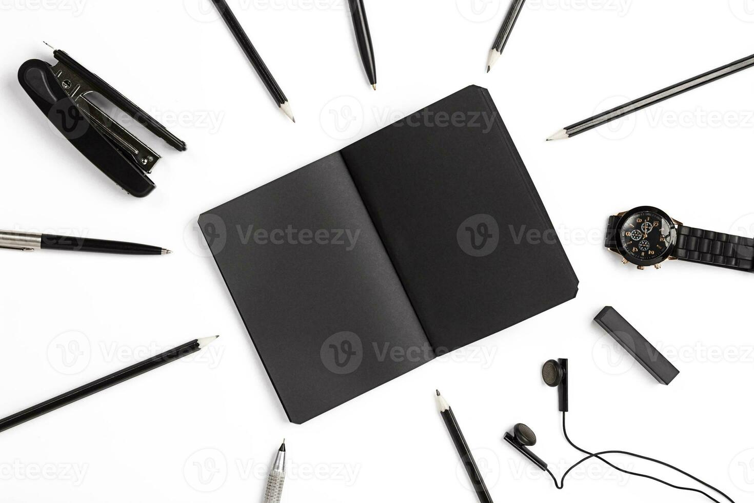 Blank notepad with clips, pens and glasses flat lay. photo
