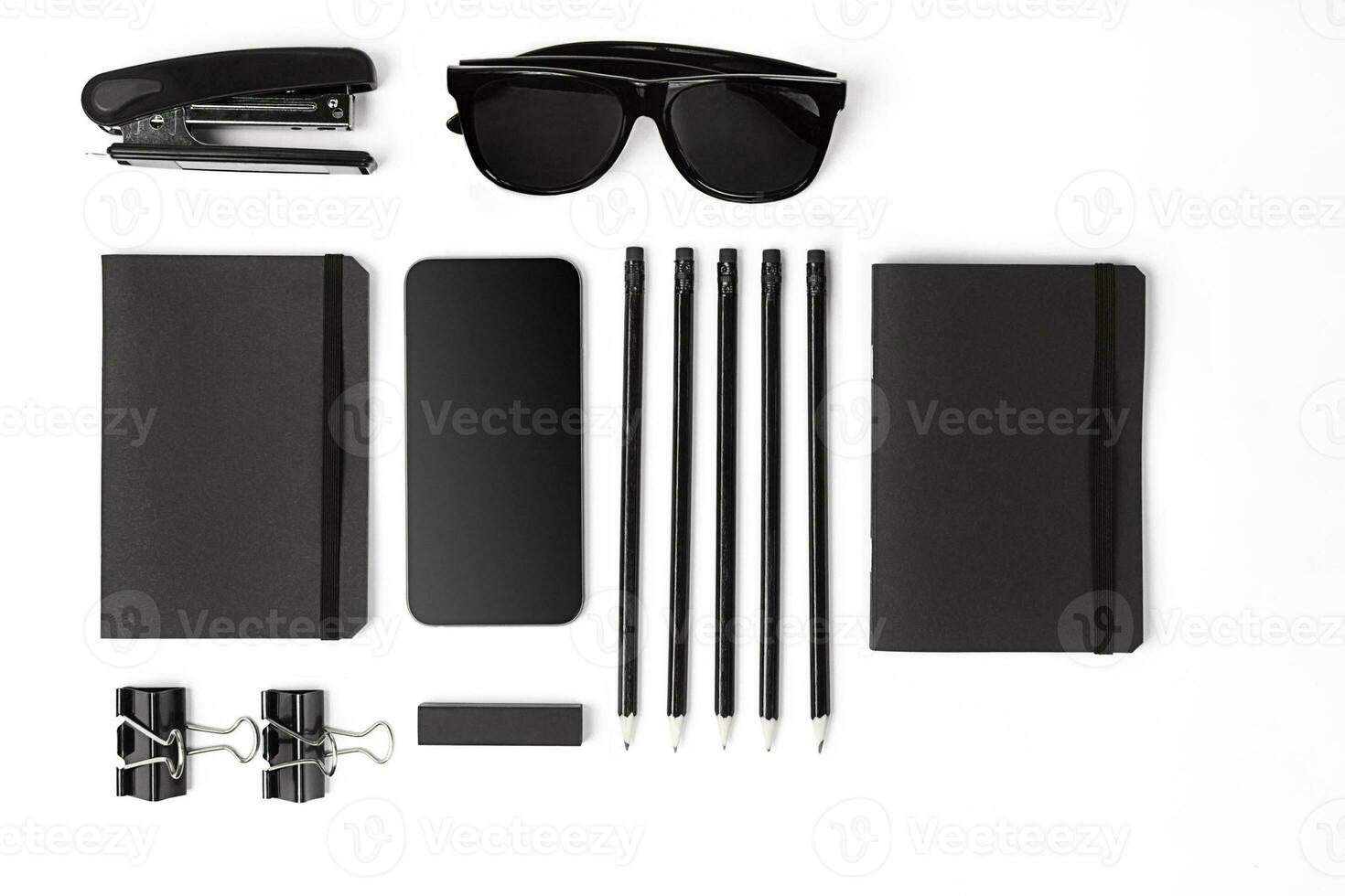 Blank notepad with clips, pens and glasses flat lay. photo