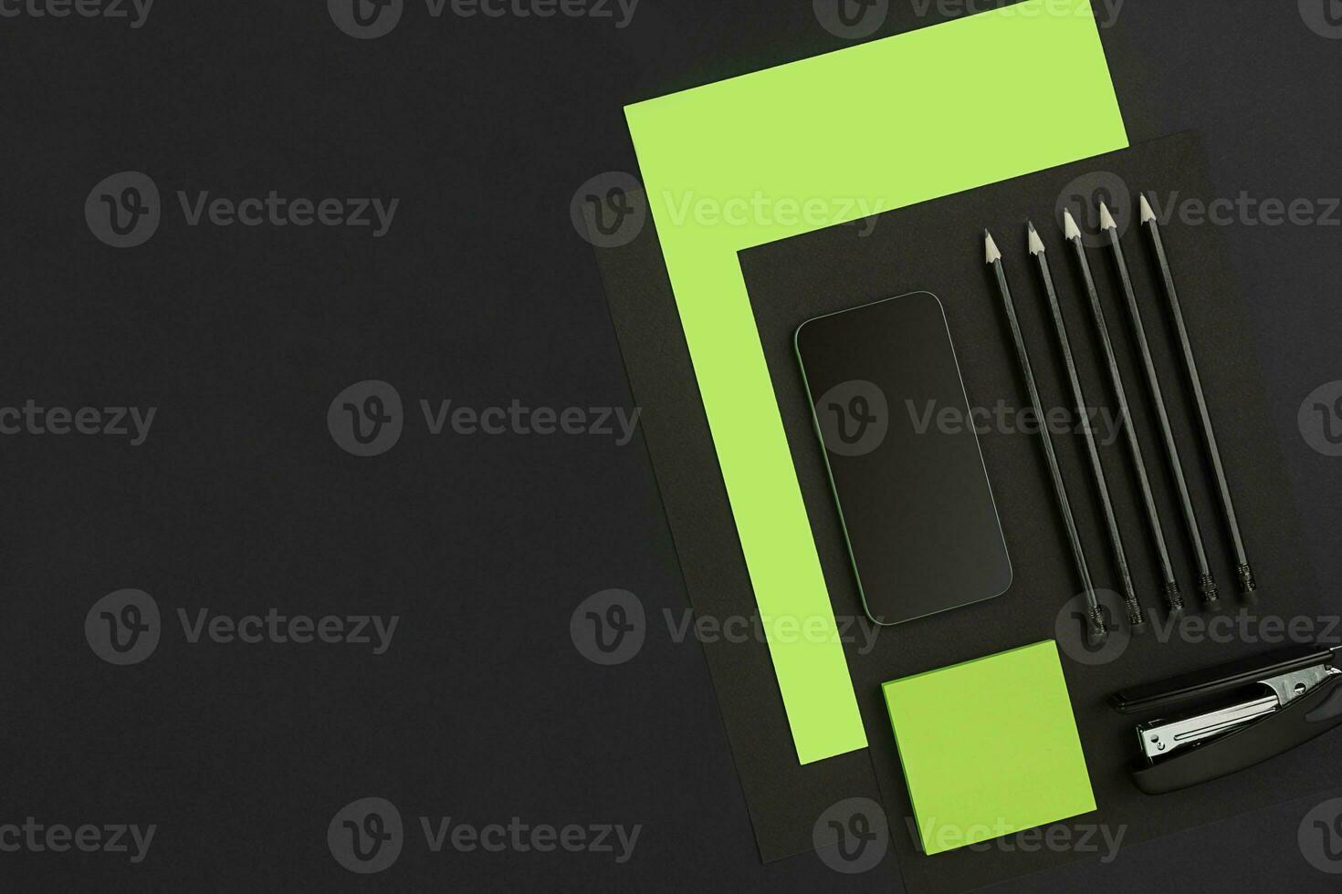 Top view of office supplies on blackboard background with copy space. photo