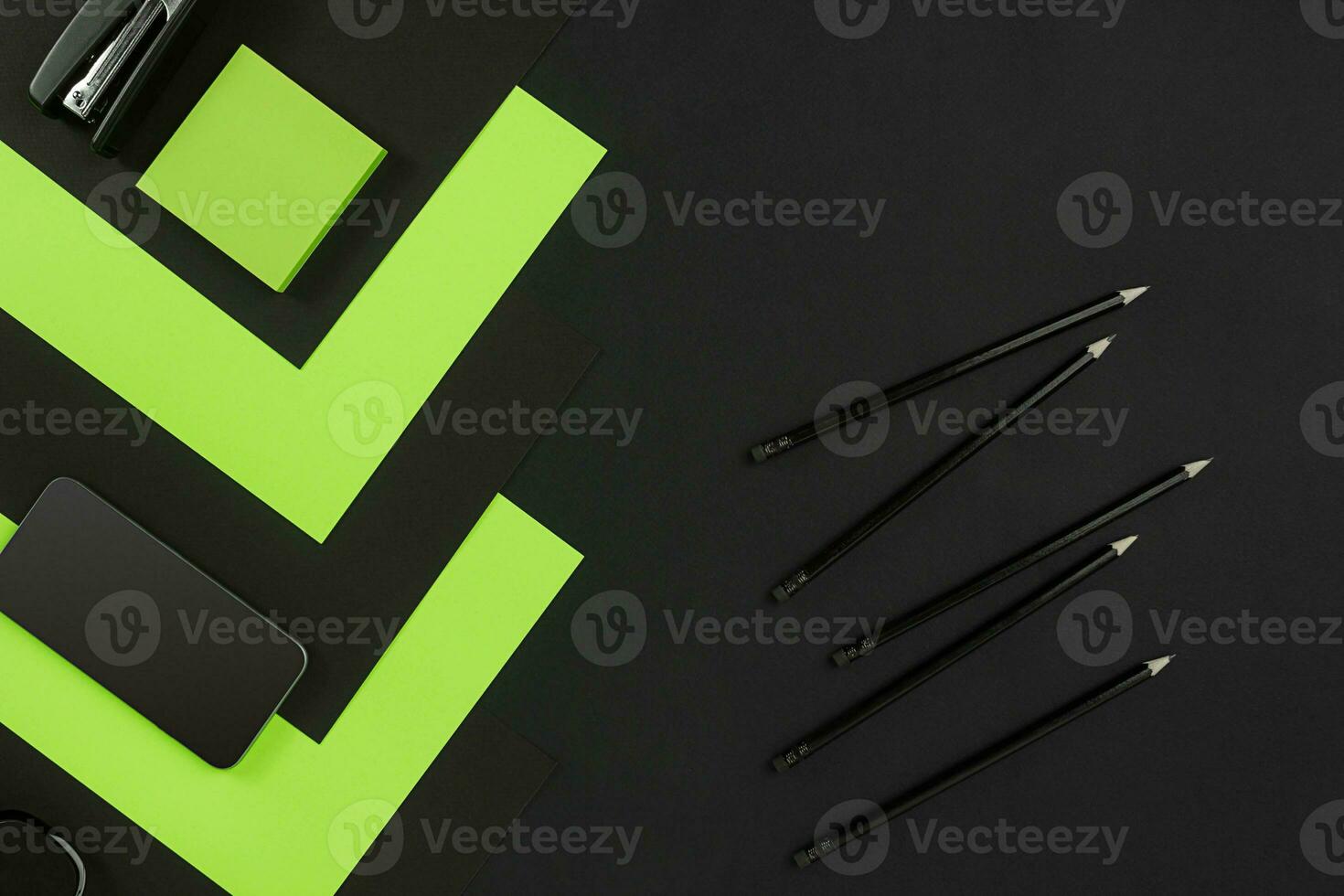 Top view of office supplies on blackboard background with copy space. photo