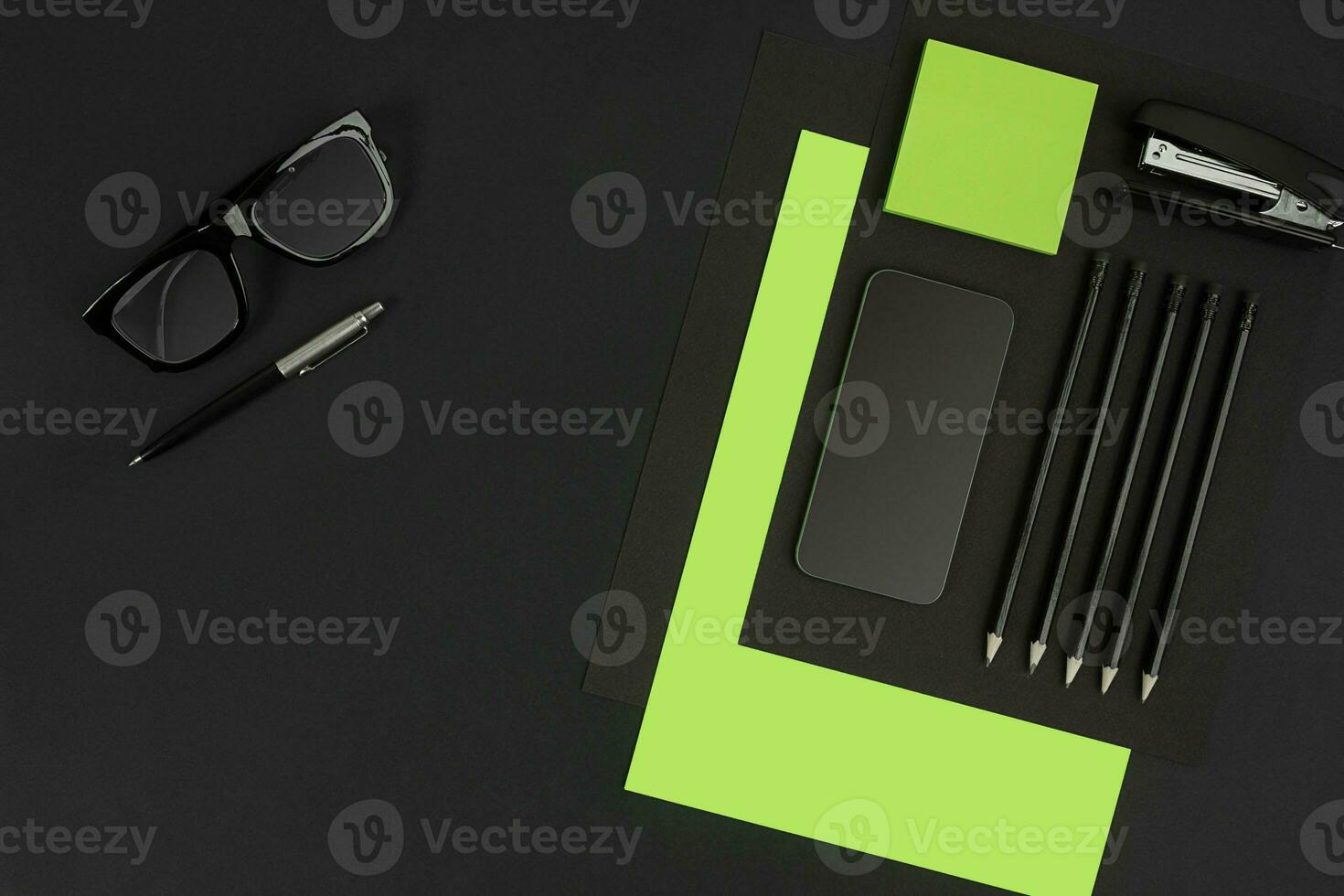Top view of office supplies on blackboard background with copy space. photo