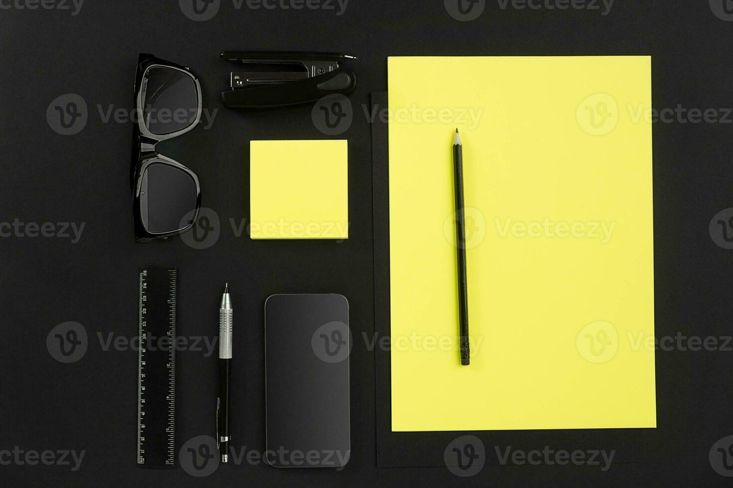 Top view of office supplies on blackboard background with copy space. photo
