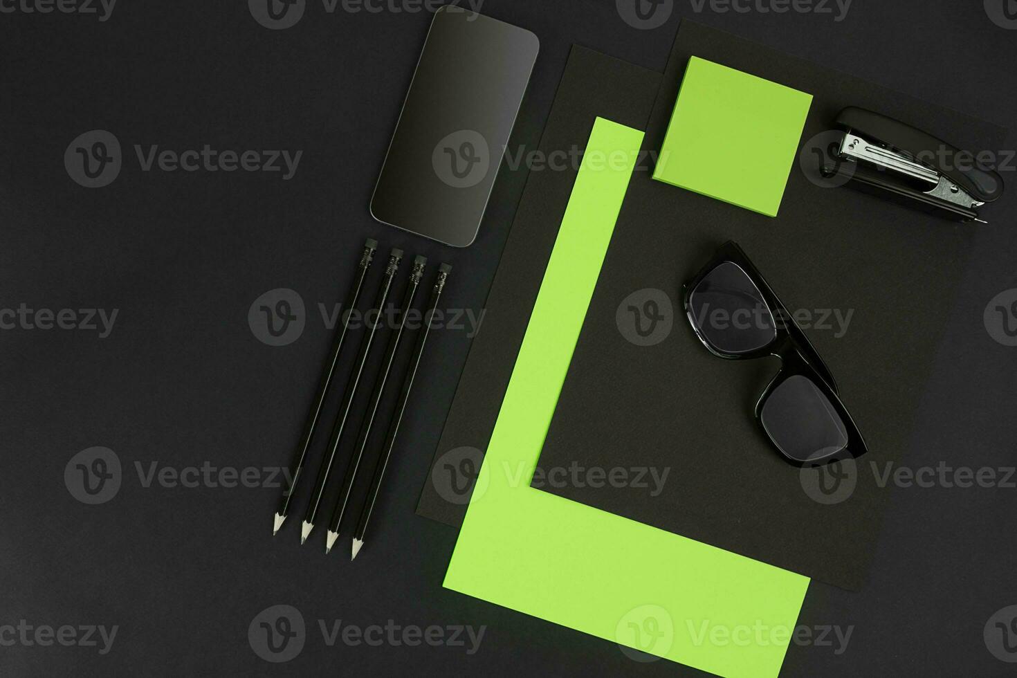 Top view of office supplies on blackboard background with copy space. photo