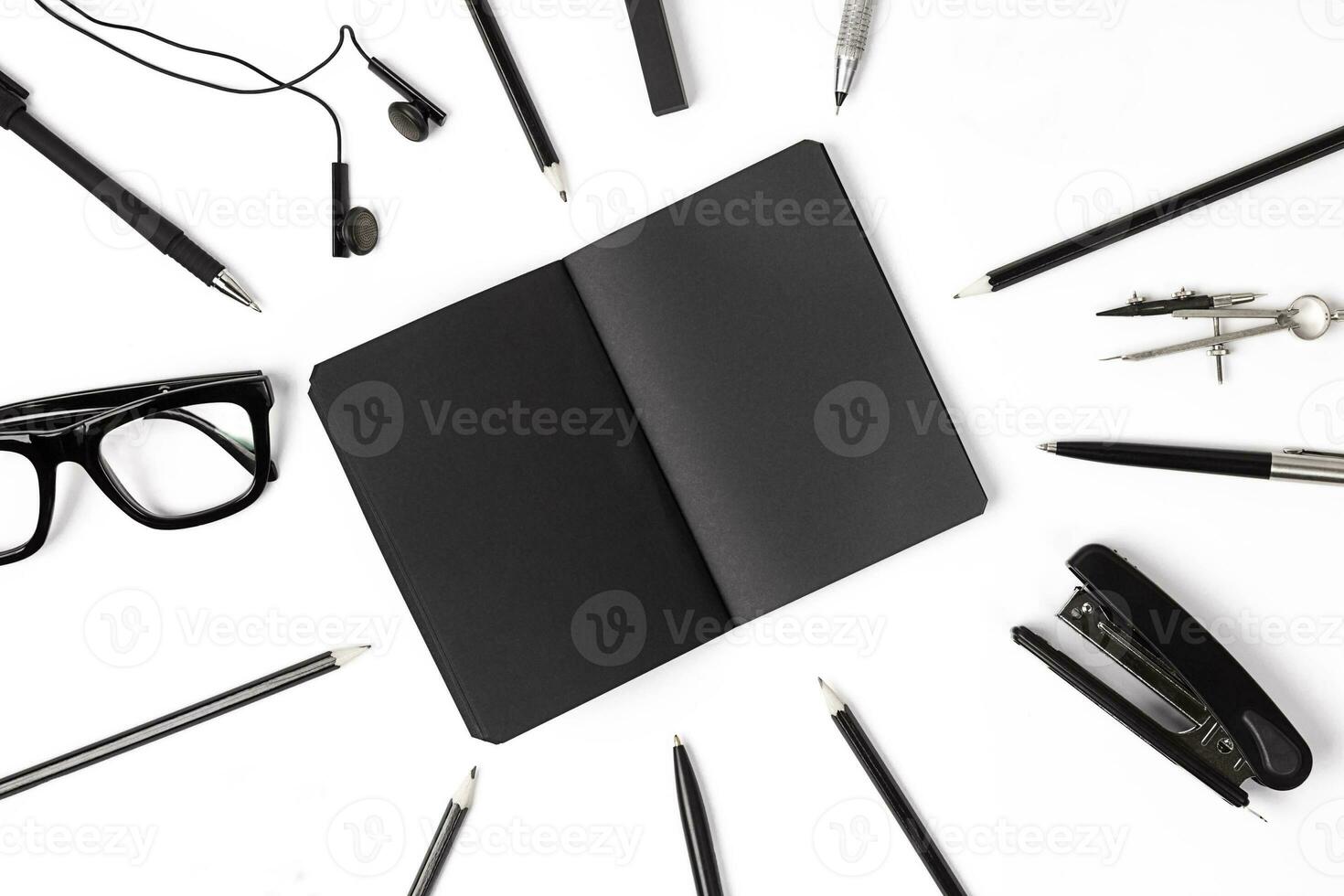 Blank notepad with clips, pens and glasses flat lay. photo