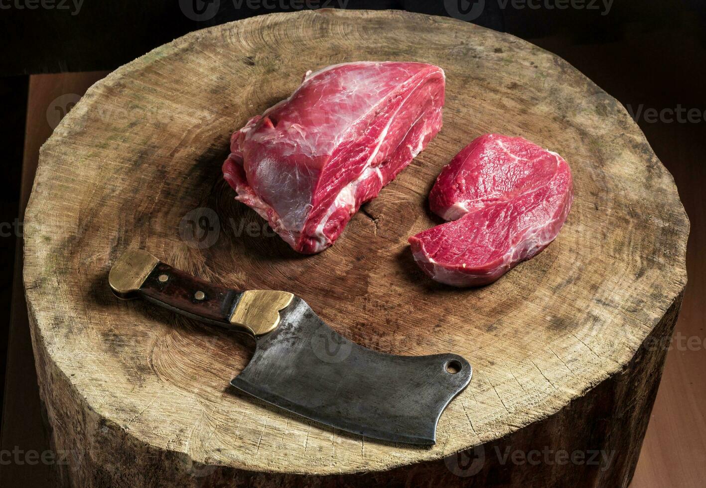 Juicy raw beef steak on wooden table photo