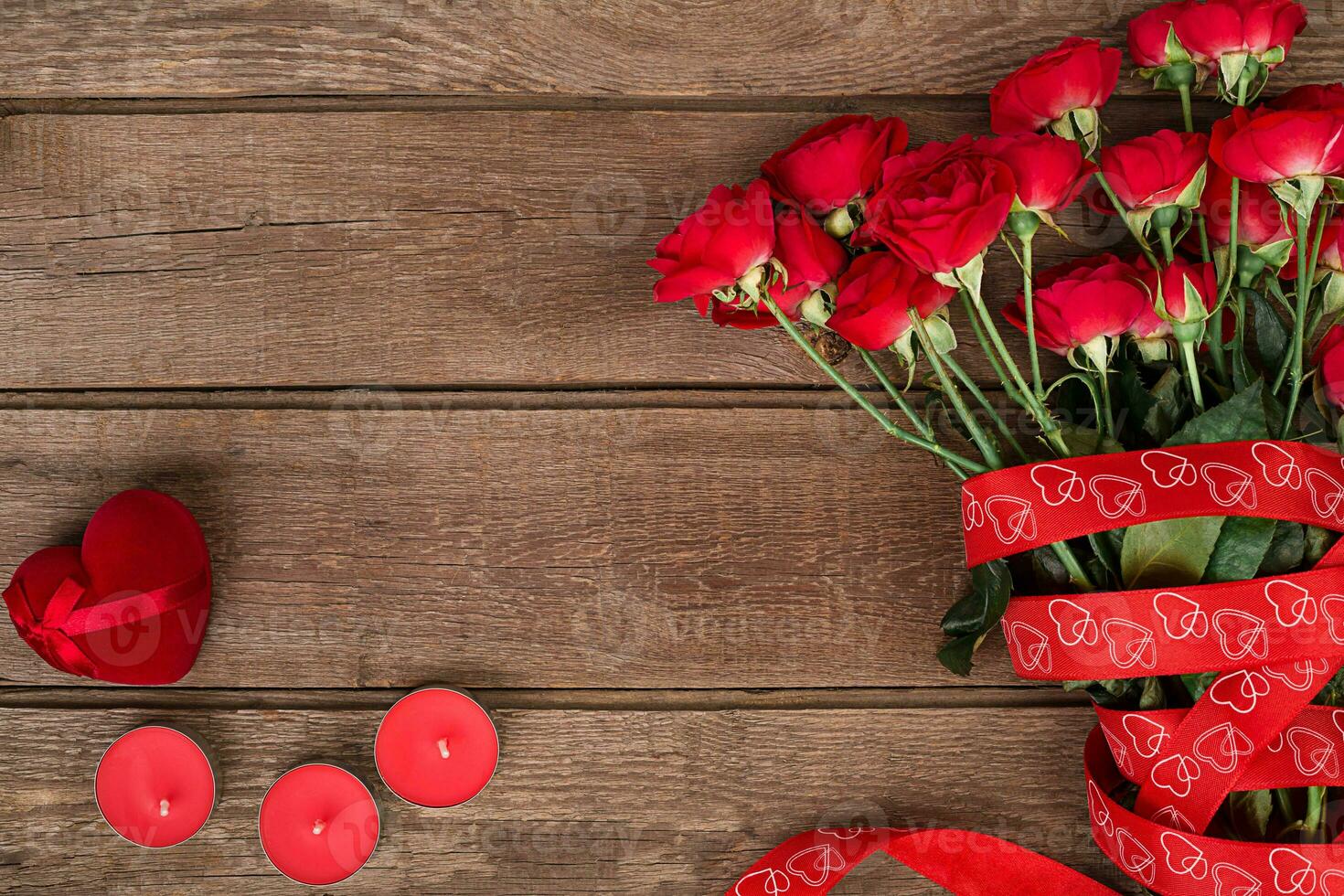 Red roses on wooden background. photo