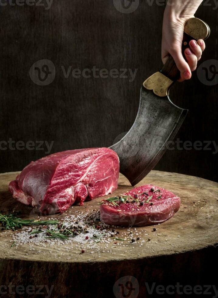 Juicy raw beef steak on wooden table photo