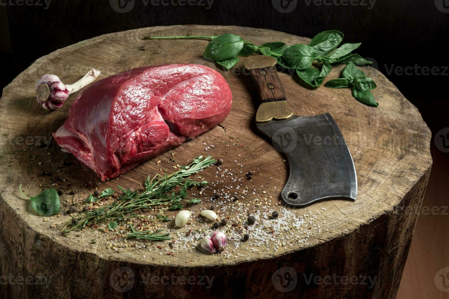 Juicy raw beef steak on wooden table photo