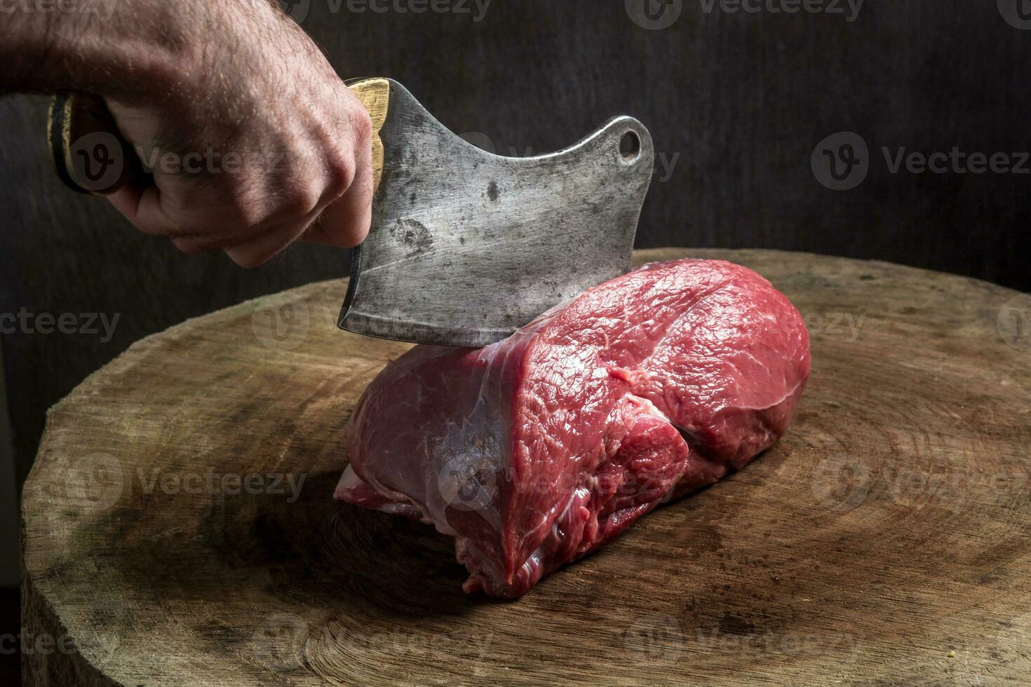 Juicy raw beef steak on wooden table photo