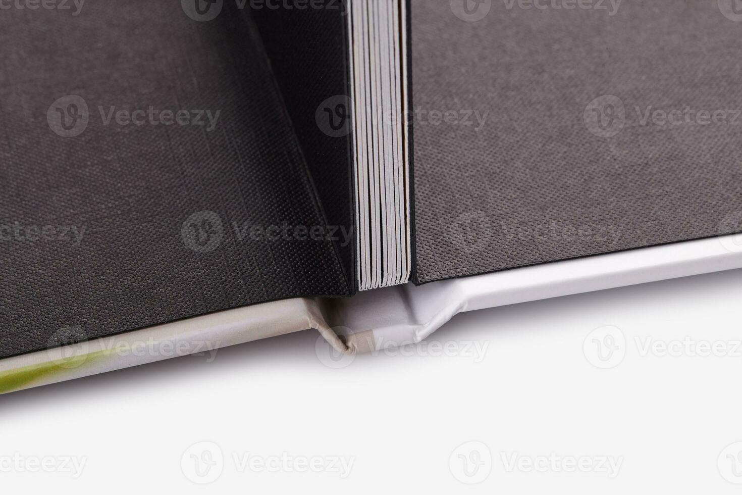 Open, high quality photo book with hardback, in colorful cover on white studio background. Close up, copy space