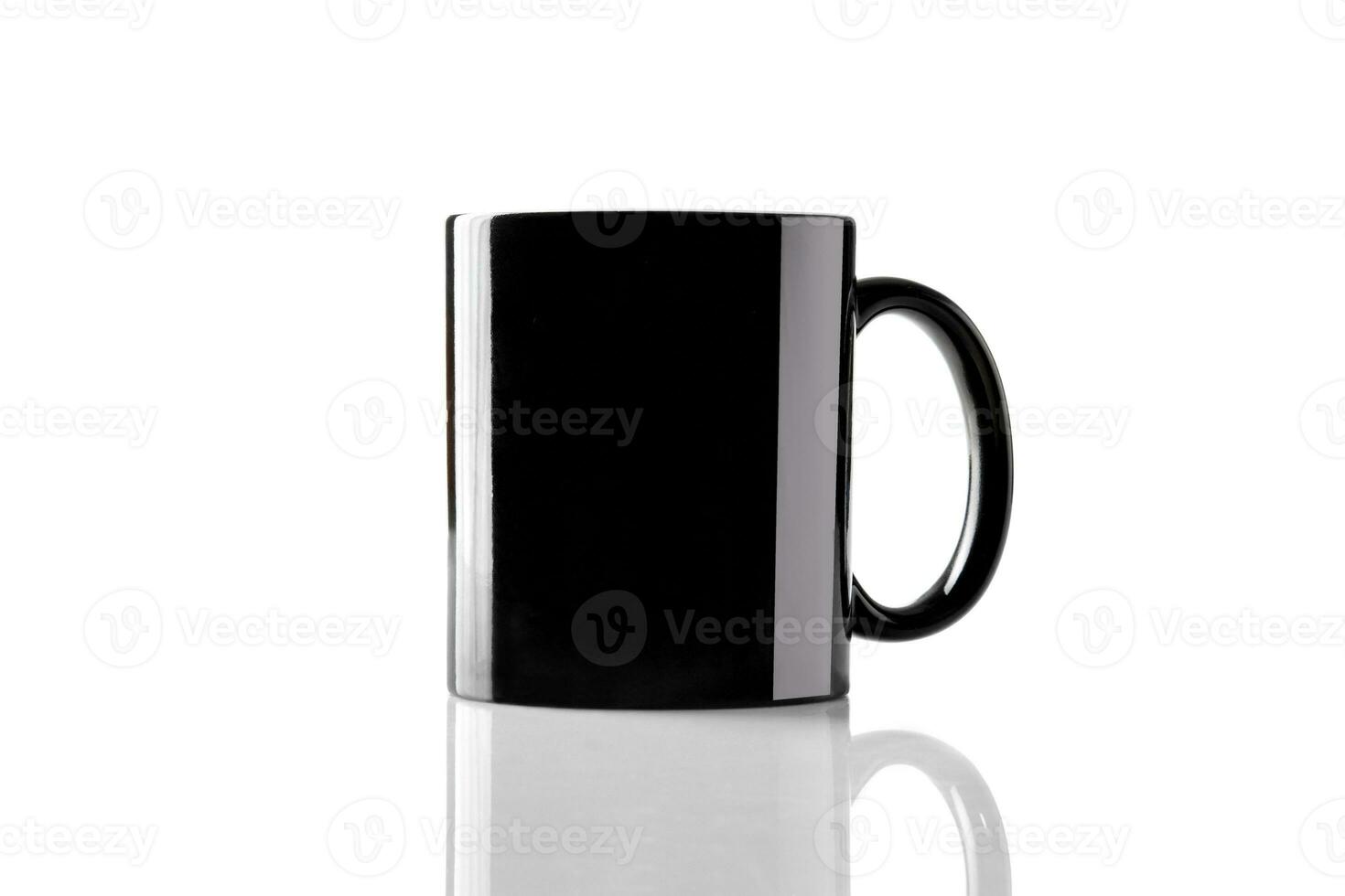 Black porcelain mug for coffee or tea on glossy surface isolated on white studio background. Mock up, template. Branding area. Close up, copy space photo