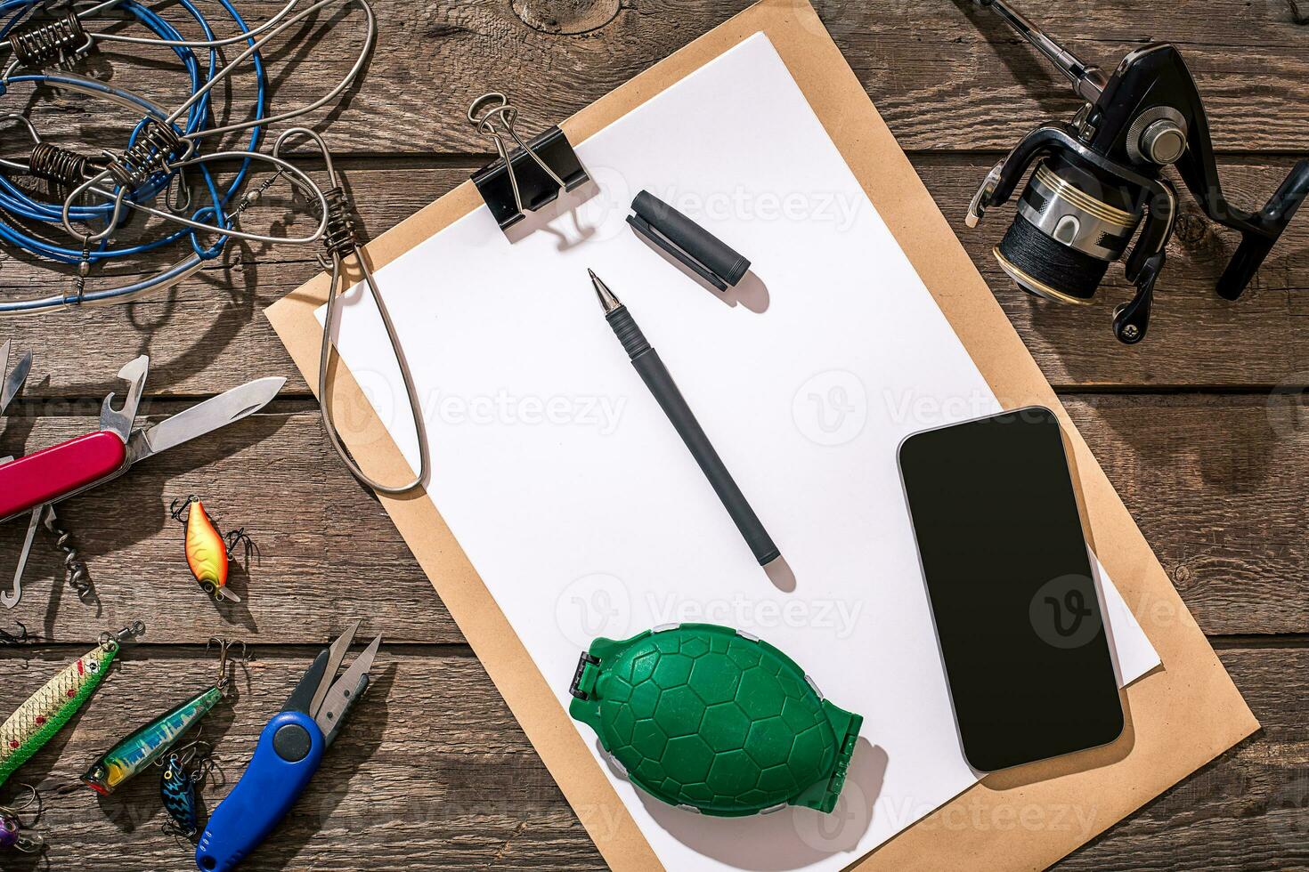 Fishing tackle - fishing spinning, fishing line, hooks and lures on wooden background. photo