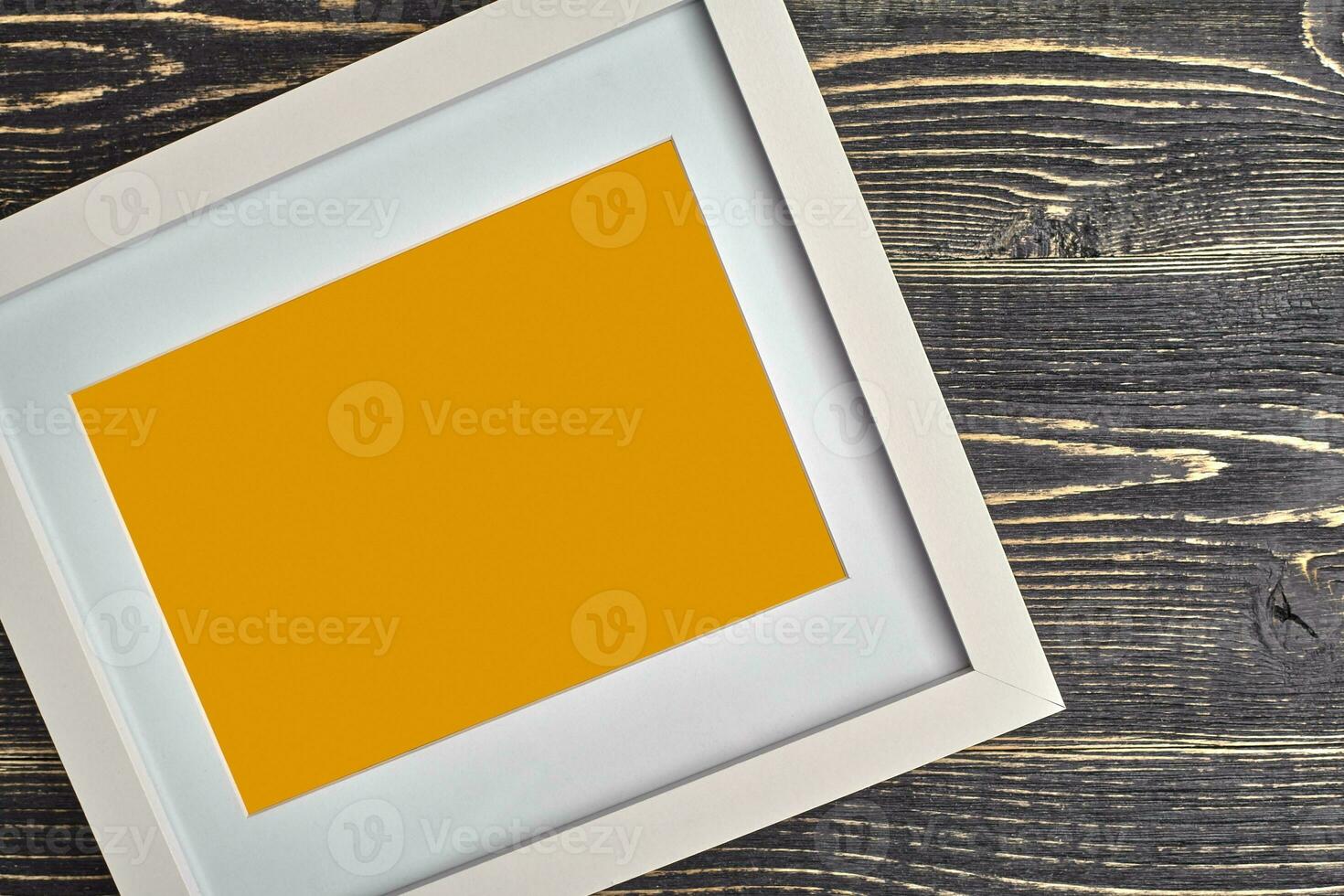White and orange modern empty photo frame on wooden background or desktop. Close up, copy space for your text or images