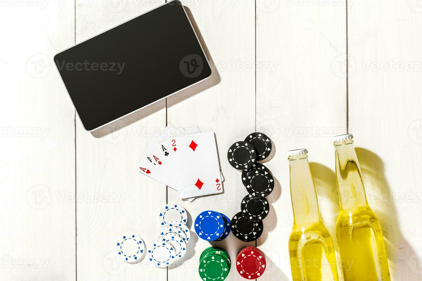 Poker. Set to playing poker with cards and chips on white wooden table, top view photo