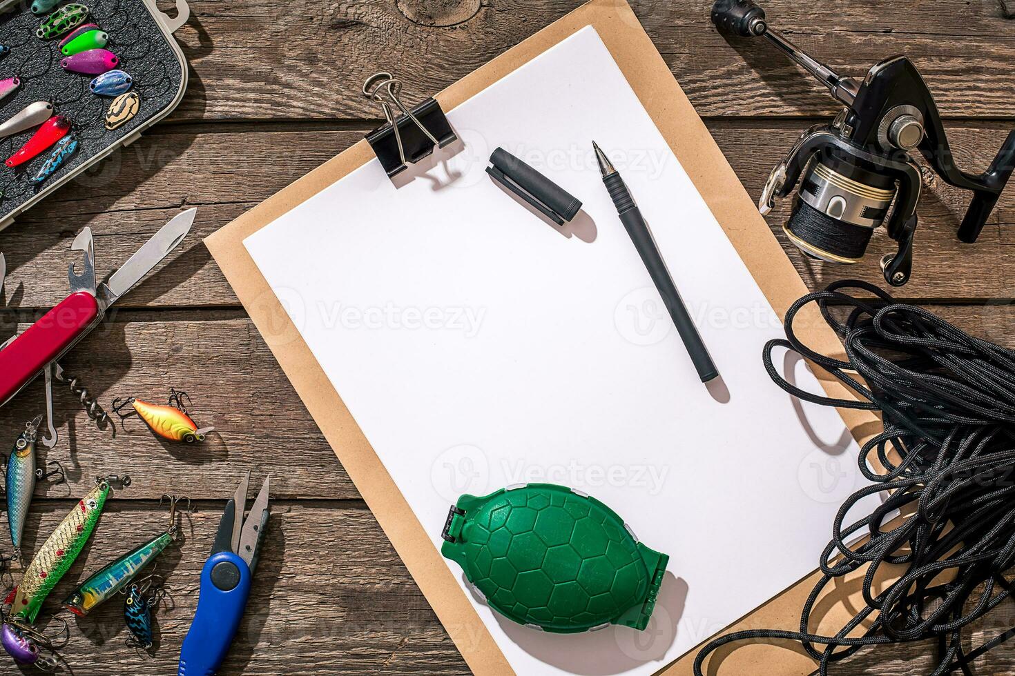 Fishing tackle - fishing spinning, fishing line, hooks and lures on wooden background. photo