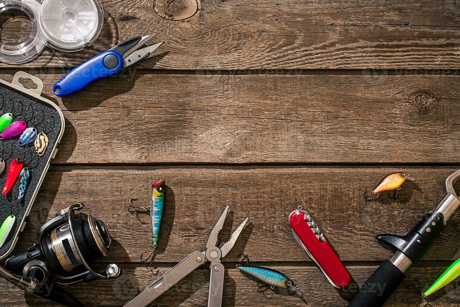 Accessories for fishing on the background of wood. Top view photo