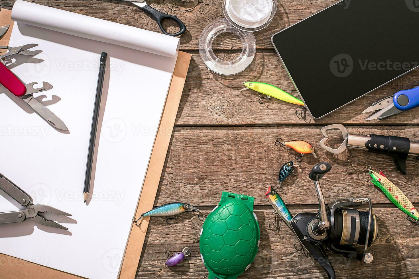 Fishing tackle - fishing spinning, fishing line, hooks and lures on wooden background. photo