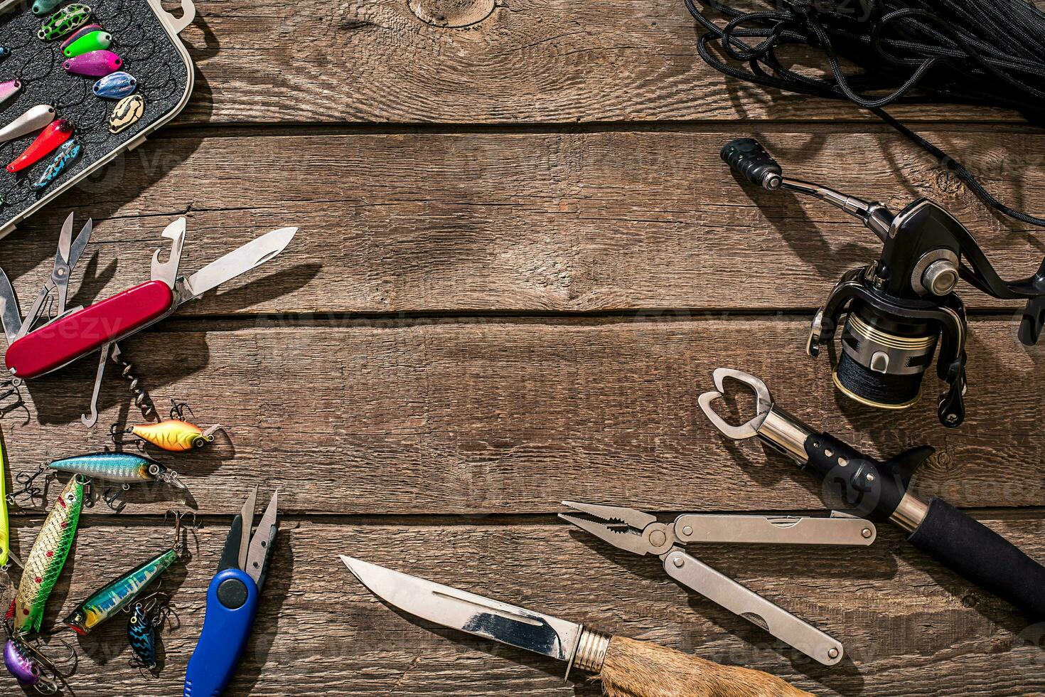 Accessories for fishing on the background of wood. Top view photo