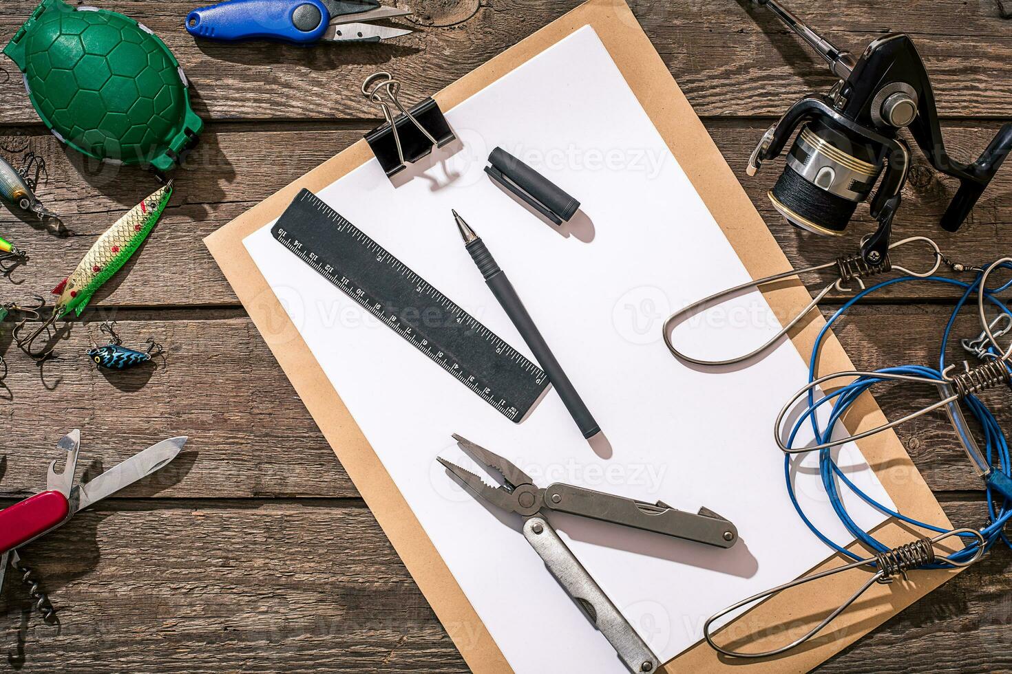 Fishing tackle - fishing spinning, fishing line, hooks and lures on wooden background. photo