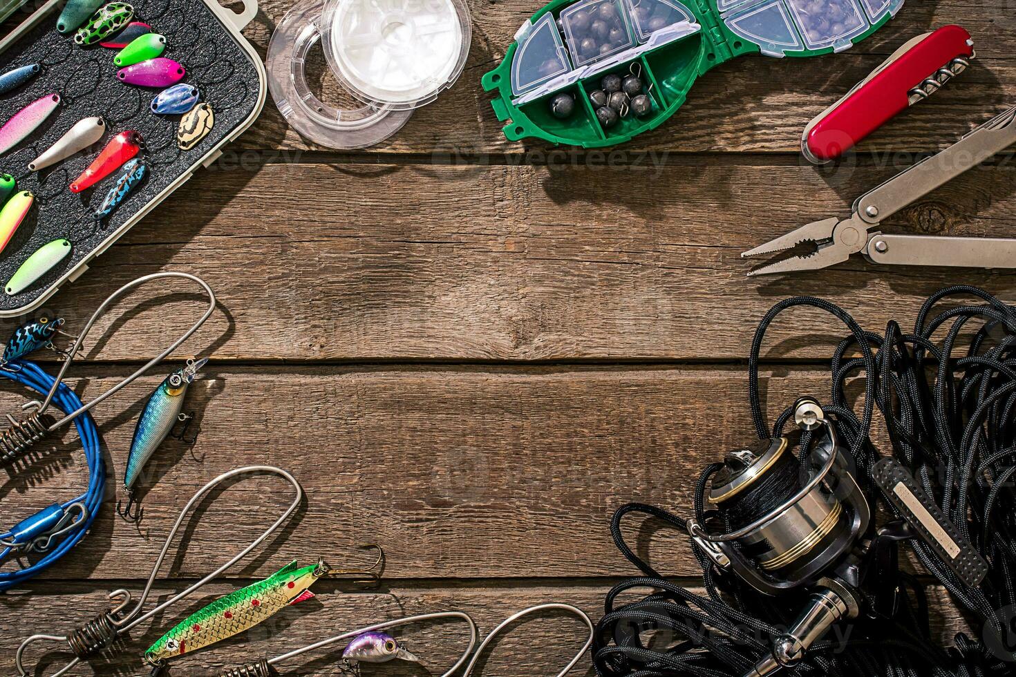 Accessories for fishing on the background of wood. Top view photo