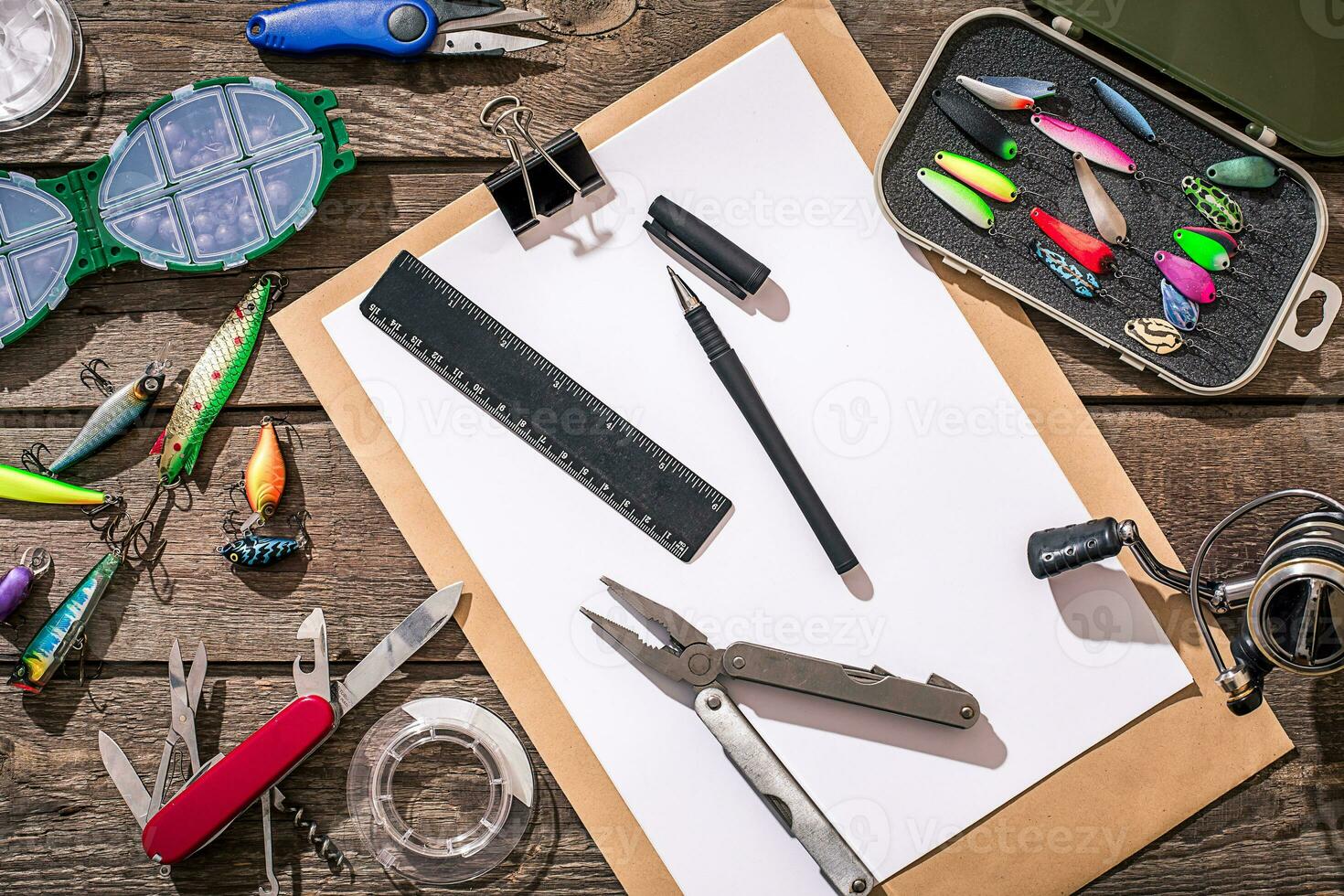 Accessories for fishing on the background of wood. Top view photo