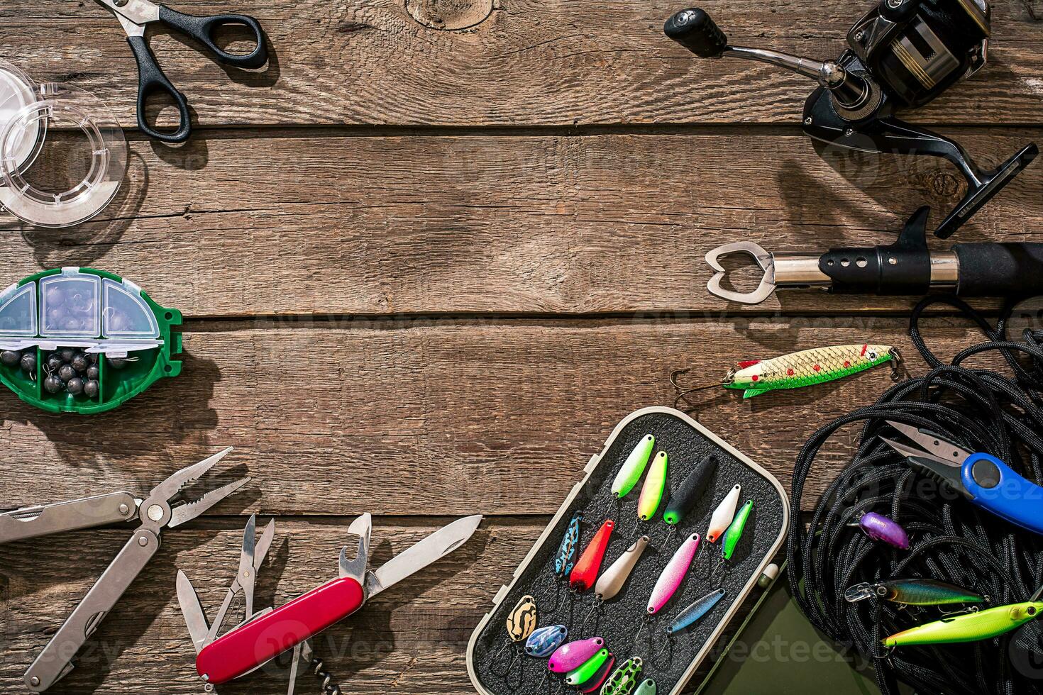 Accessories for fishing on the background of wood. Top view photo