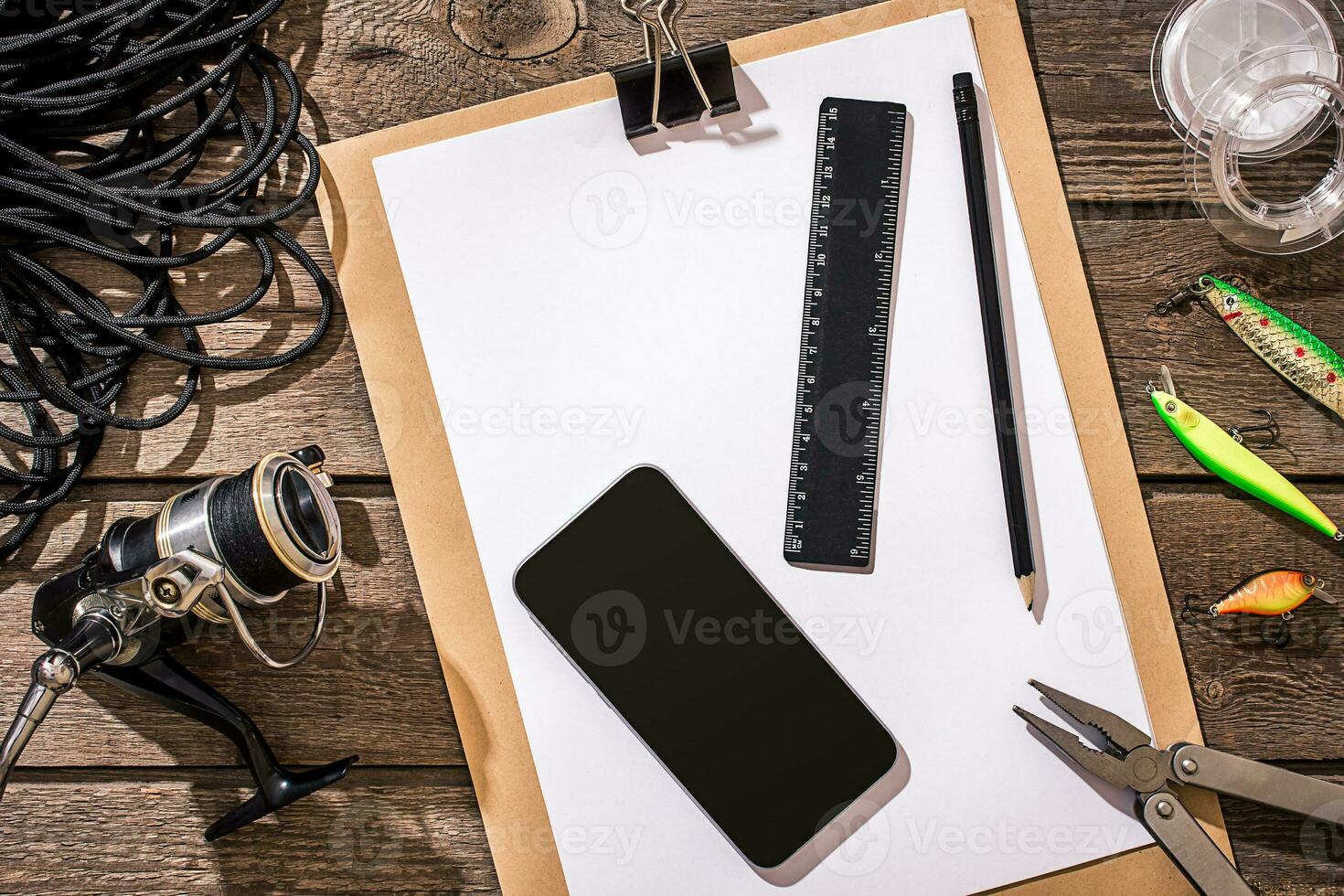 Accessories for fishing on the background of wood. Top view photo