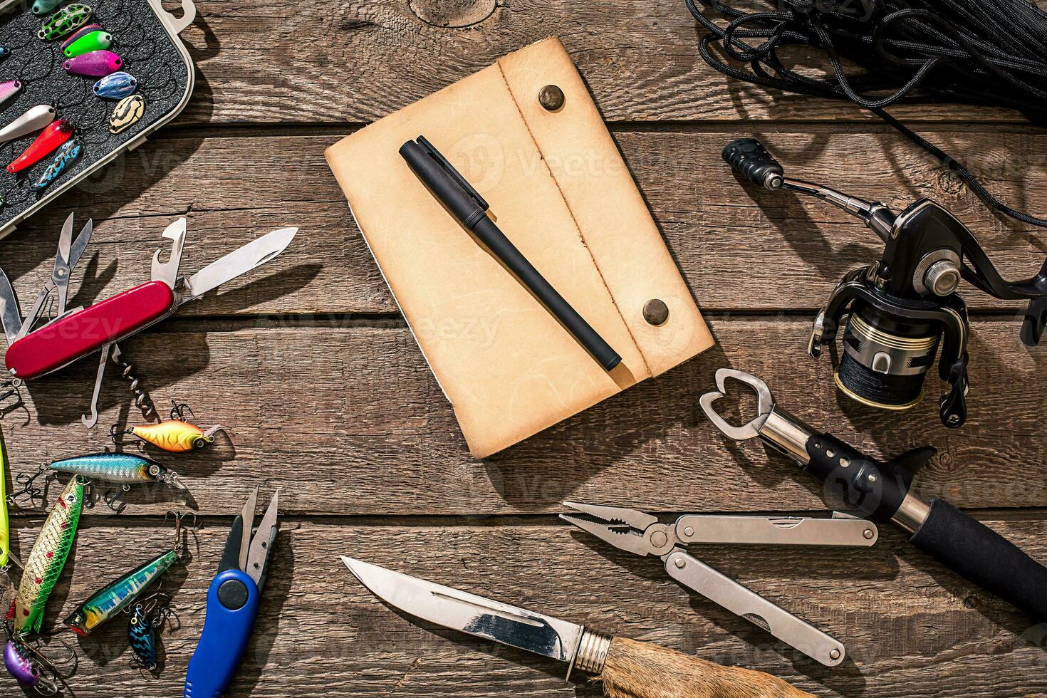 Accessories for fishing on the background of wood. Top view photo