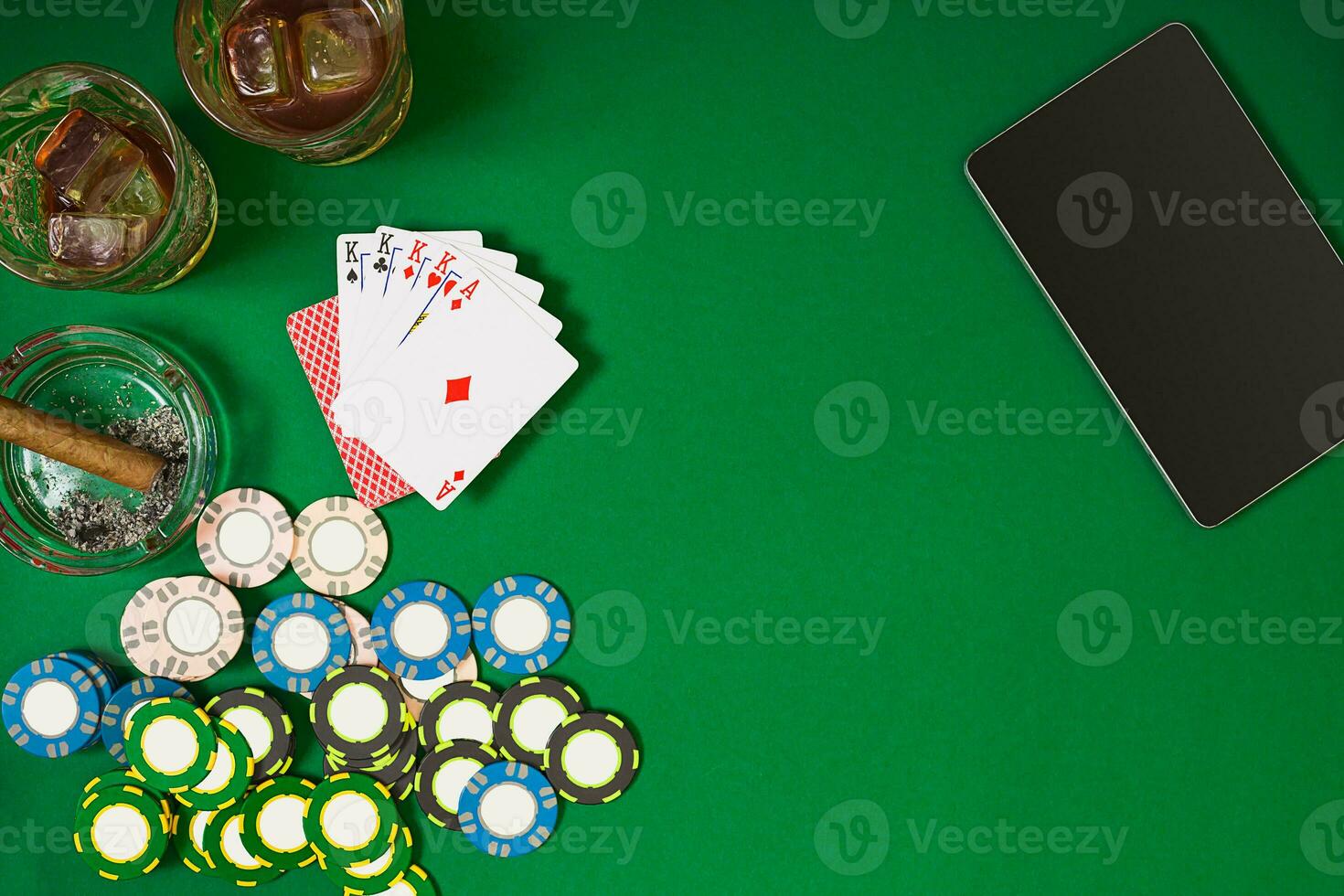 Set to playing poker with cards and chips on green table, top view photo