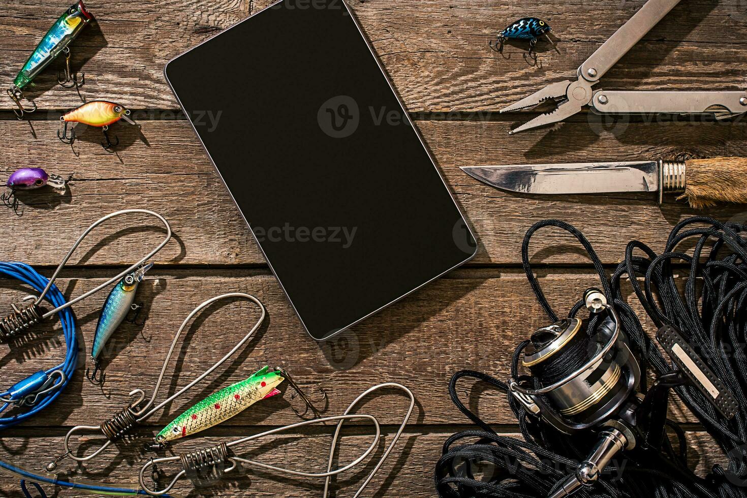 Accessories for fishing on the background of wood. Top view photo