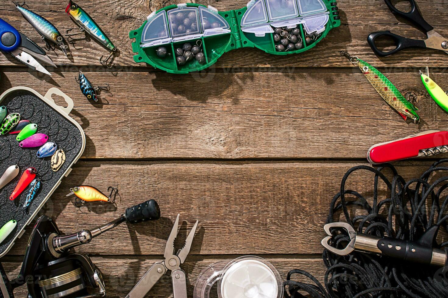 Accessories for fishing on the background of wood. Top view photo