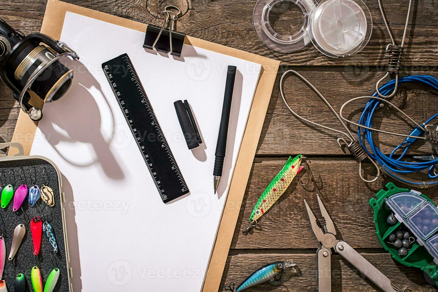 Accessories for fishing on the background of wood. Top view photo