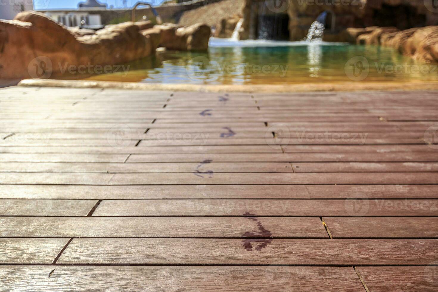 Closeup footprints on the wooden floor behind it swimming pool photo