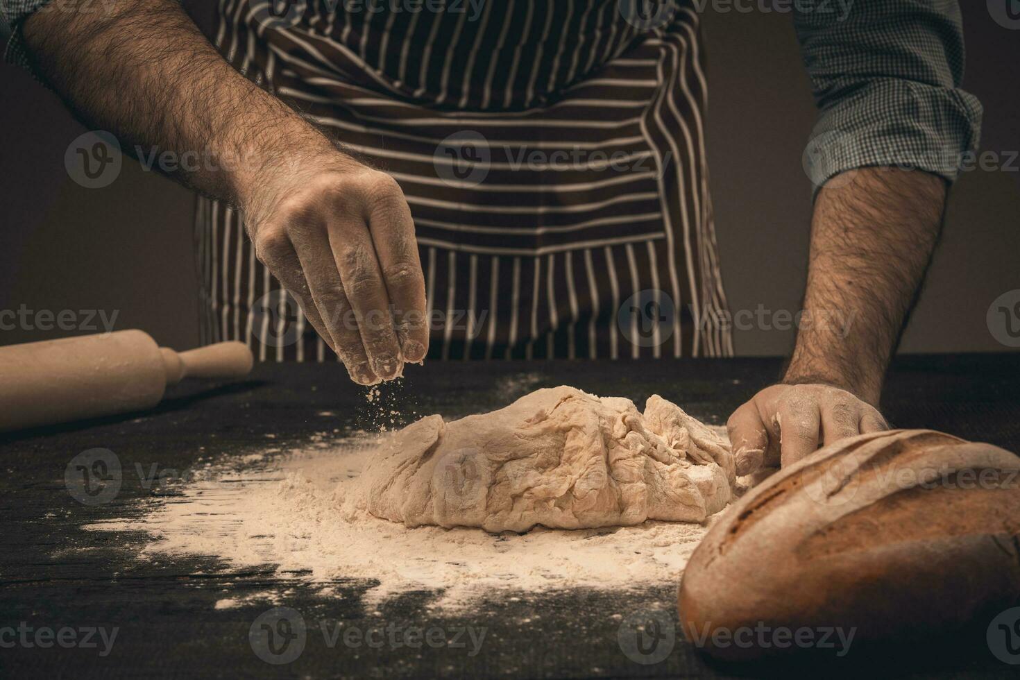 Male hands knead the dough. photo
