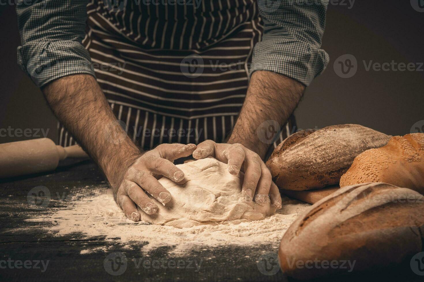 Male hands knead the dough. photo