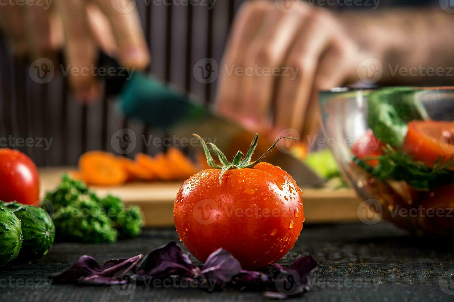 Male hands cutting vegetables for salad photo
