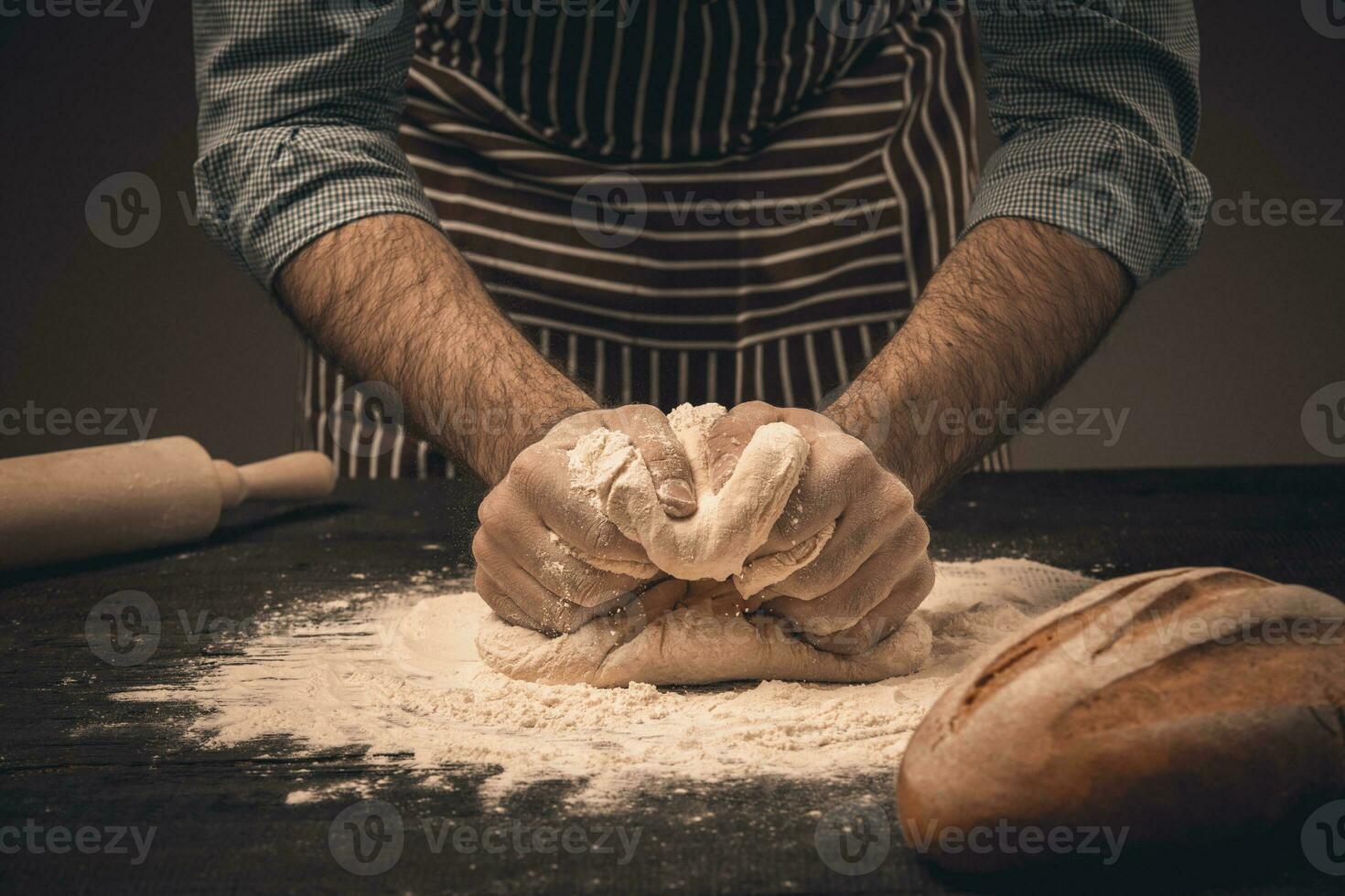 Male hands knead the dough. photo