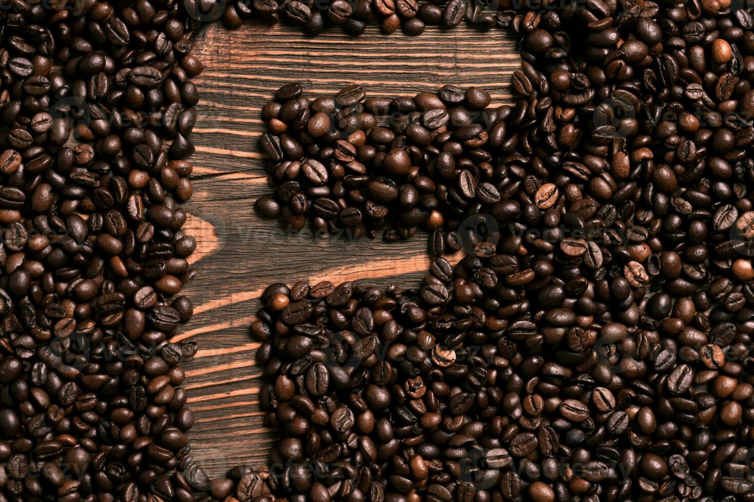 Letter F inscription with coffee bean on the wooden table photo