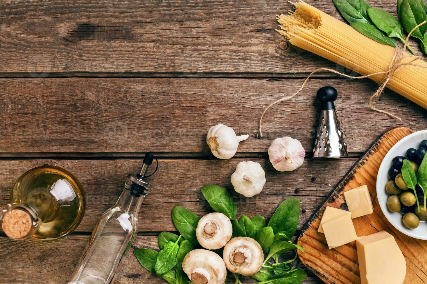 Italian food background with pasta, spices and vegetables. Top view, copy space. photo