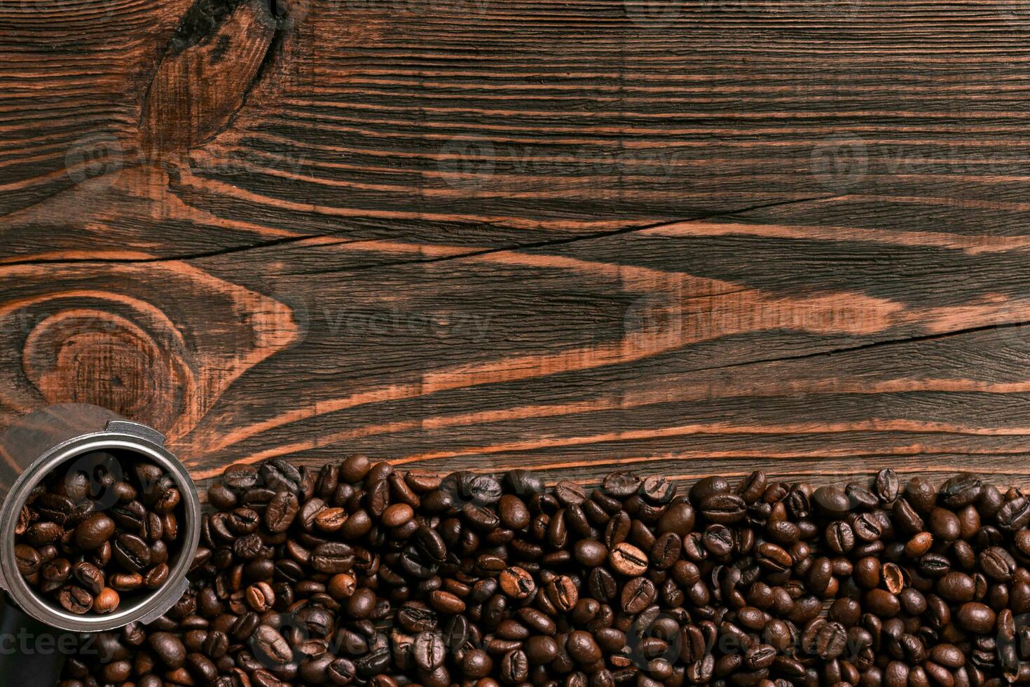 Coffee beans on wooden table texture with copy space. View from photo