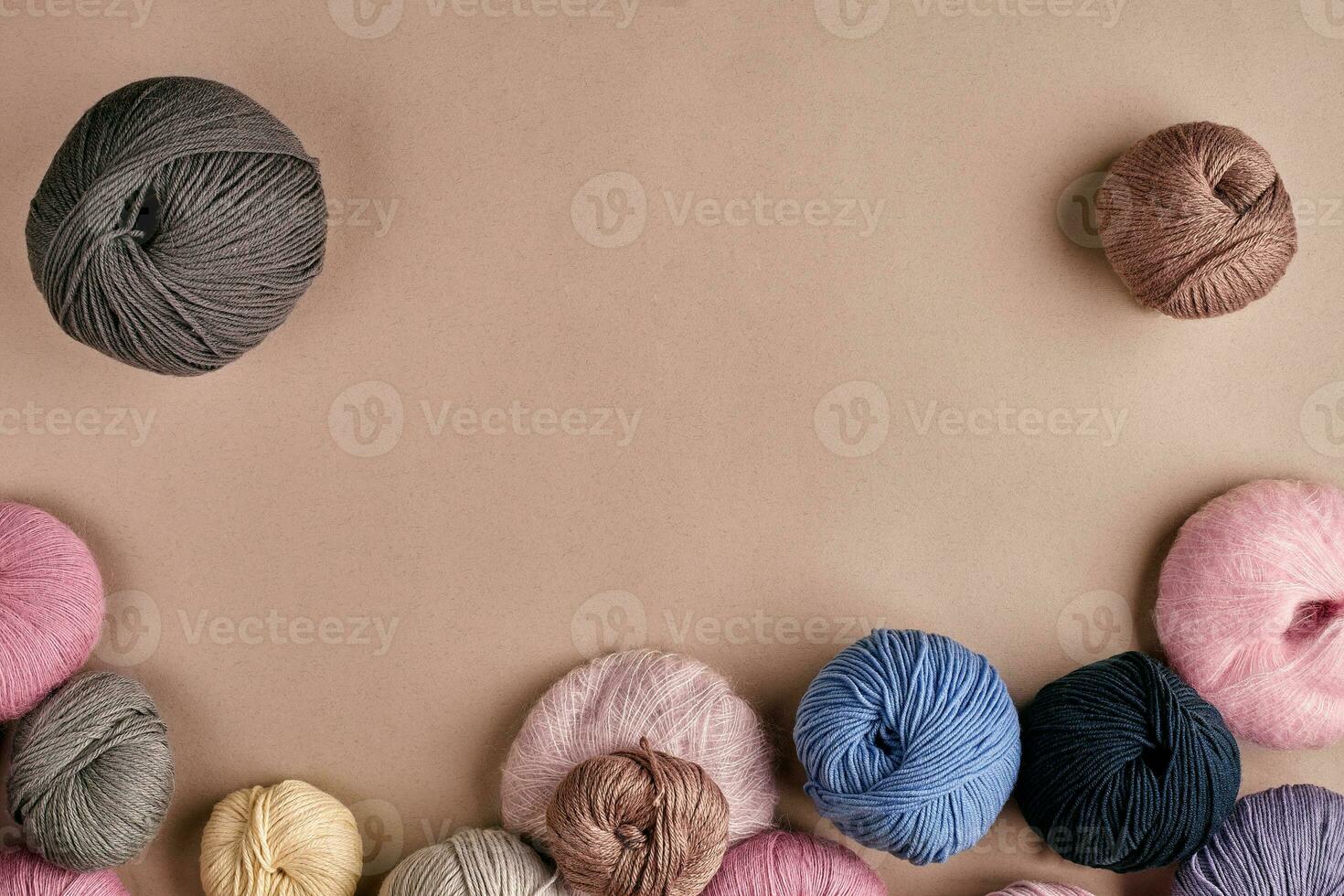 Set of colorful wool yarn on beige background. Top view photo