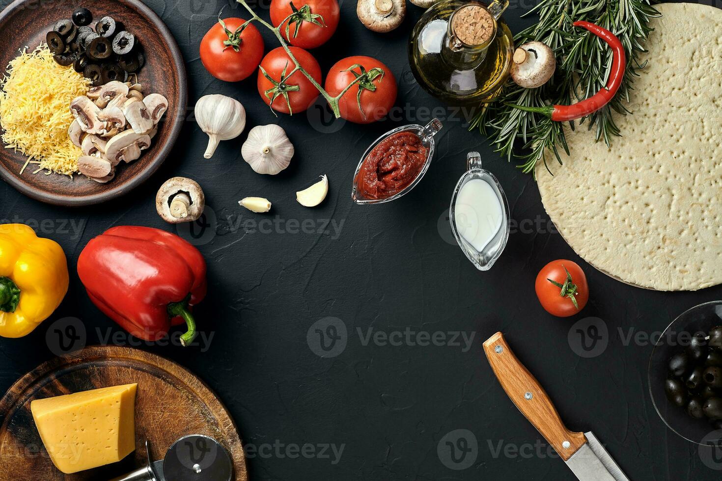 Pizza cooking ingredients. Dough, vegetables and spices. Top view with copy space photo