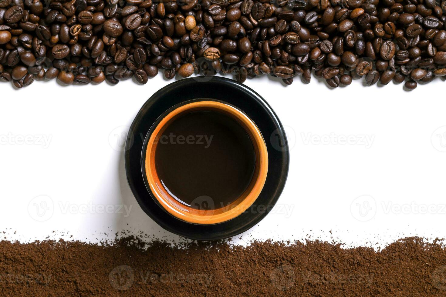 White background with cup of coffee, coffee beans and ground coffee on below and above. photo