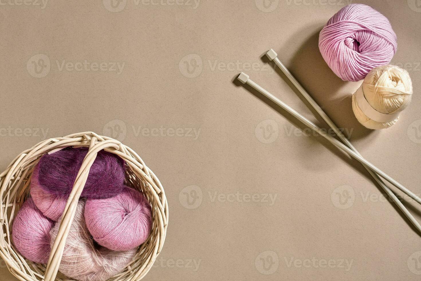 Balls of woolen threads and knitting needles. Scandinavian style. Threads for knitting in a basket. photo