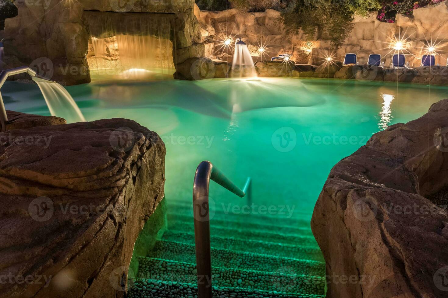 Evening view for luxury swimming pool in night illumination photo