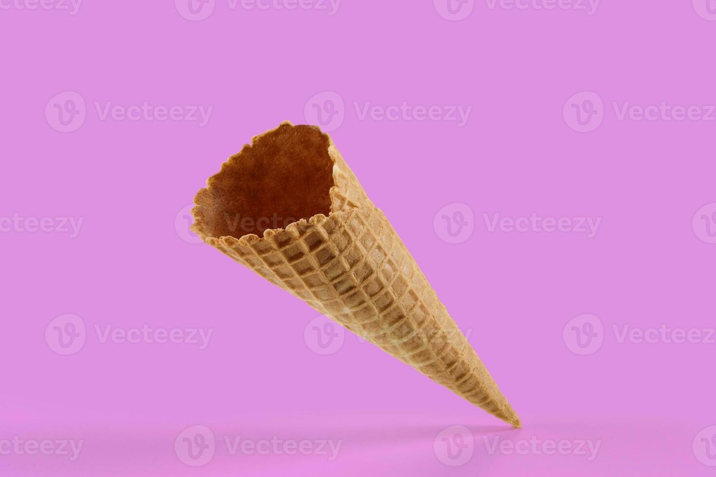 Empty, crunchy wafer cone for ice cream against pink background. Concept of food, treats. Mockup, template for your advertising and design. Close up photo