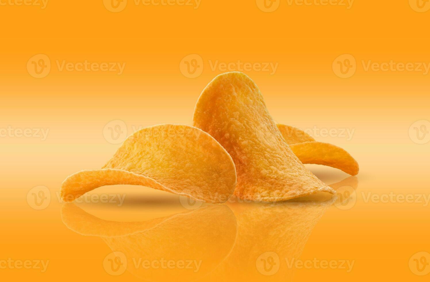 Potato crisps on a yellow background with copy space for text or images, mirror surface. Advertising concept. Close-up shot. photo